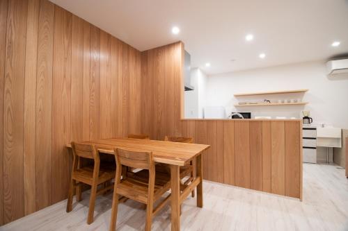 a dining room with a wooden table and chairs at ユニテ蔵王ジョーニダ リゾート in Yamagata