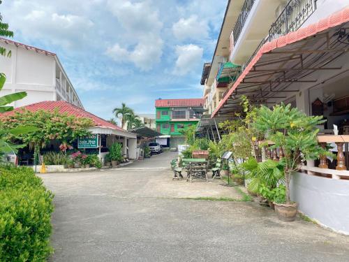 an empty street with tables and chairs and buildings at 2 Vikings Guesthouse in Karon Beach