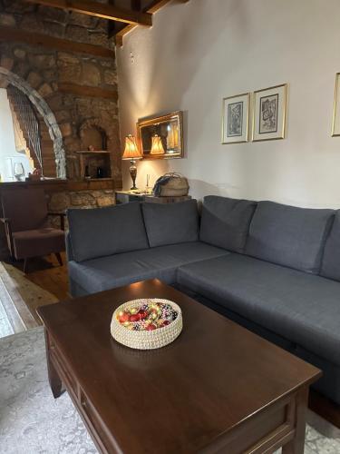 a living room with a blue couch with a pizza on a table at Urban River House in Florina