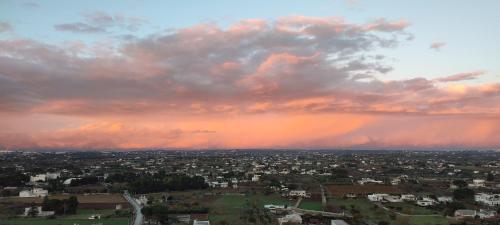 a view of a city with a rainbow in the sky at Balcone in Valle d'Itria in Martina Franca
