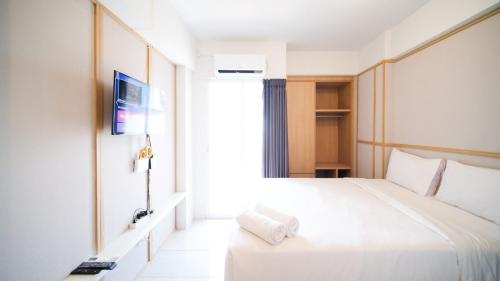 Cette chambre comprend un lit et une télévision. dans l'établissement Studio Apartment at Suncity Residence Sidoarjo near Suncity Mall By Travelio, à Sidoarjo