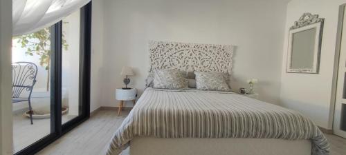 sypialnia z dużym łóżkiem z dużym lustrem w obiekcie LA MAISON DE MARIE A 8 mn des plages w Perpignanie