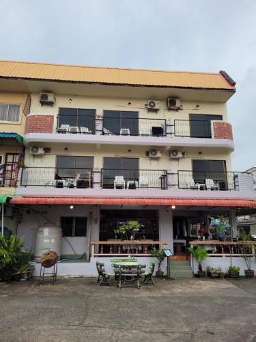 a building with a table in front of it at 2 Vikings Guesthouse in Karon Beach