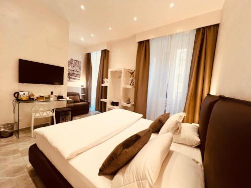 a hotel room with two beds and a television at DolceVitaSuite in Rome