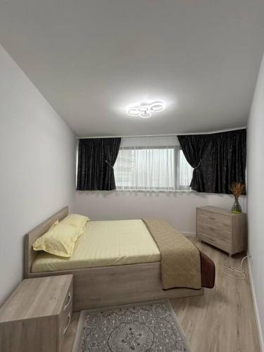 a bedroom with a bed and a window at Apartament 3 camere zona Areni complex nou in Suceava
