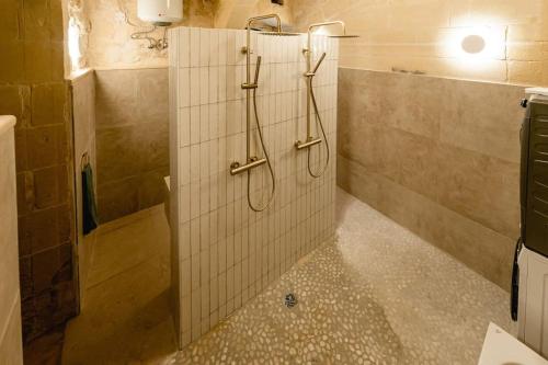 baño con ducha con 2 mangueras en la pared en Charming & Stylish Historic Farmhouse with Pool, en Xewkija