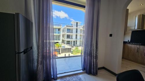 a large window with a view of a building at Residence Oceana 4 in Mont Choisy