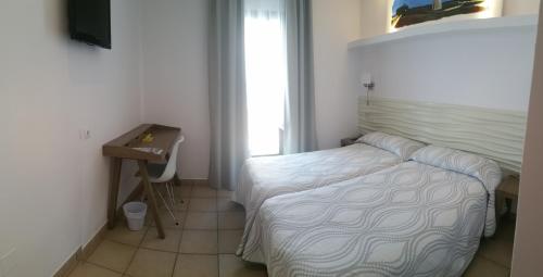 Ένα ή περισσότερα κρεβάτια σε δωμάτιο στο Hotel Bahía