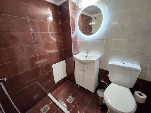a bathroom with a toilet and a sink and a mirror at Gazi Apartment with Breakfast in Athens