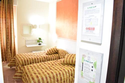 a room with two couches and a sign on the wall at Hotel Il Parco in Grosseto