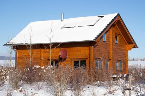 a wooden house with a snow covered roof at Ecolodge 2 in Medebach