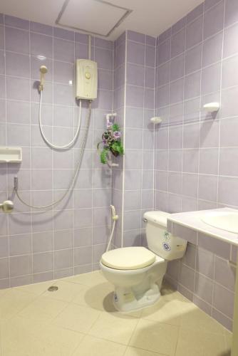 a bathroom with a shower and a toilet and a sink at B-Home Residence in Patong Beach