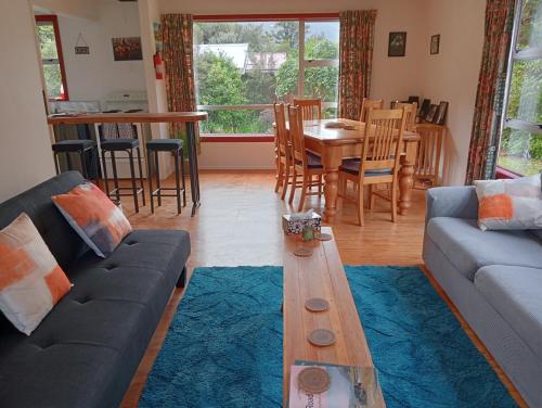 a living room with a couch and a table at Rata Lodge Accommodation in Otira