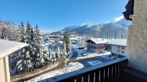 a view from a balcony of a town in the snow at Markus Apartment in Strobl