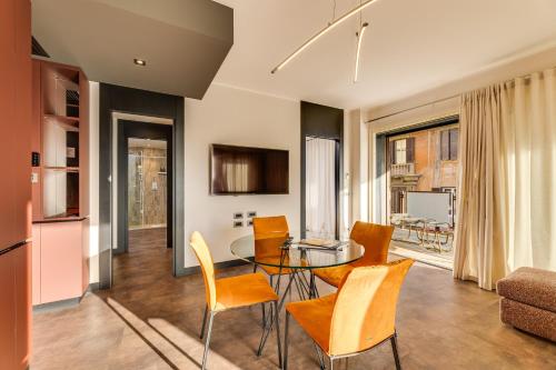 a kitchen and living room with a table and chairs at Gasometer Urban Suites in Rome