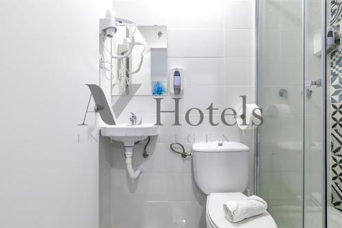 a bathroom with a toilet and a sink and a shower at AYZ Ulises - Auto check-in property in Madrid
