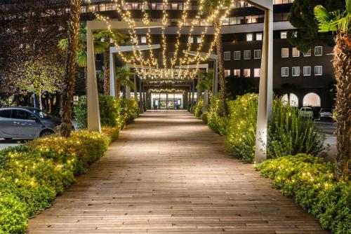 a walkway leading into a building with christmas lights at Du Lac Et Du Parc Grand Resort in Riva del Garda