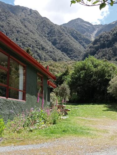 a house with a view of mountains at Rata Lodge Accommodation in Otira