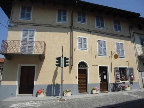a building with a traffic light in front of it at 4 tea 4 house in Romano Canavese