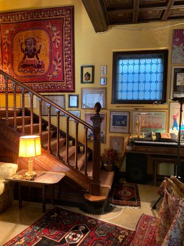 a living room with a spiral staircase and a window at Casa Lovisoni in Cervignano del Friuli