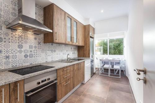 a kitchen with a sink and a stove top oven at BLife Farensya private rooms in Faro