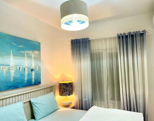 um quarto com uma cama e uma pintura de barcos em Two bedroom apartment at Fumba Town, Zanzibar em Fumba