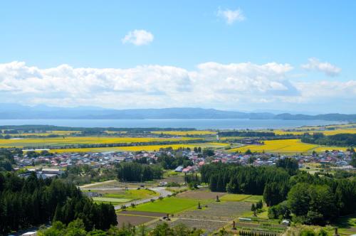 an aerial view of a town with a lake at Hotel Listel Inawashiro Wing Tower in Inawashiro
