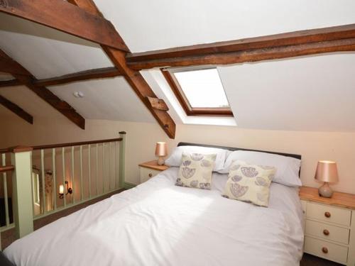 a bedroom with a white bed with two pillows at 2 bed in Watchet OLDSO in Wiveliscombe