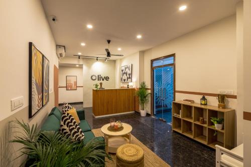 a lobby with a waiting room with a door at Olive Domlur - by Embassy Group in Bangalore