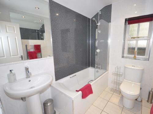 a bathroom with a sink and a toilet and a shower at 2 bed in Huntly AB171 in Huntly