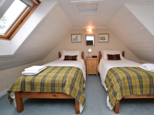 two beds in a room with a attic at 5 Bed in Castle Douglas KK169 in Castle Douglas