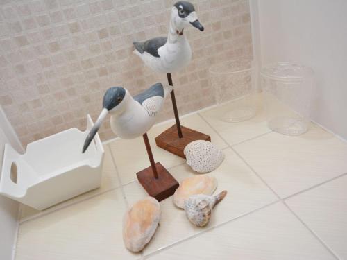 two statues of birds on a counter with rocks at 5 Bed in Castle Douglas KK169 in Castle Douglas