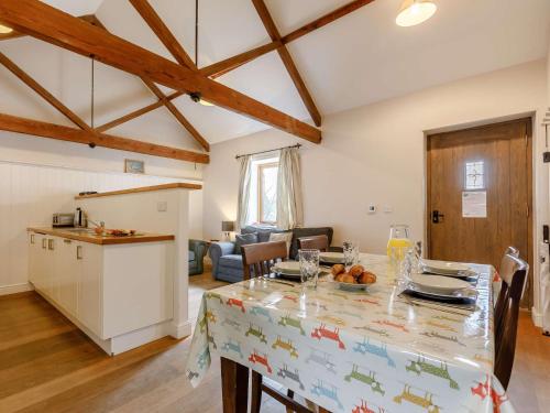 a kitchen and living room with a table and chairs at 2 Bed in Barnstaple 09091 in Umberleigh Bridge