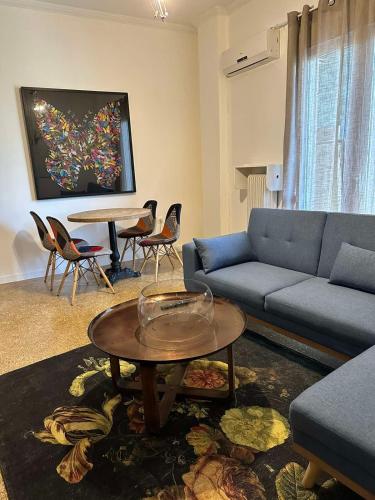 a living room with a couch and a table at Cozy Apartment at Gazi Square in Athens
