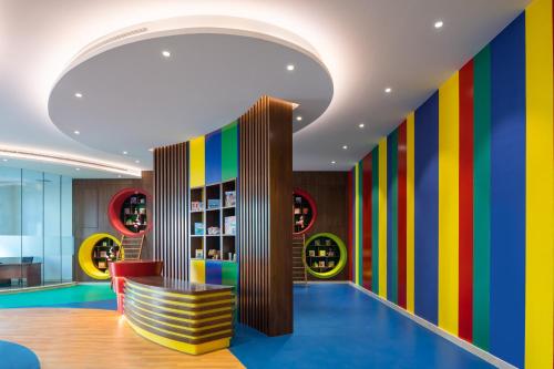 a lobby with colorful walls and a colorful bench at Radisson Resort Ras Al Khaimah Marjan Island in Ras al Khaimah