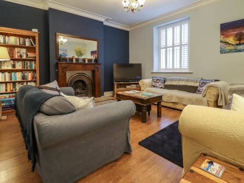 a living room with couches and a fire place at Number Seventeen in Amble