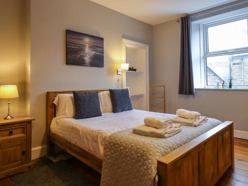 a bedroom with a bed with towels on it at Number Seventeen in Amble