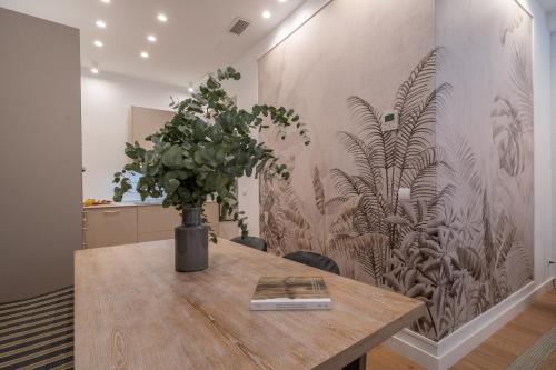 a table with a vase of plants on a wall at XPCE Cathedral - Luxury Flat in Málaga