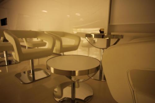 a row of chairs and tables in a waiting room at Hotel IN in Međugorje