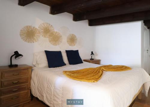 Un dormitorio con una cama con una manta. en MyStay - Casa dos Parentes, en Igrejinha