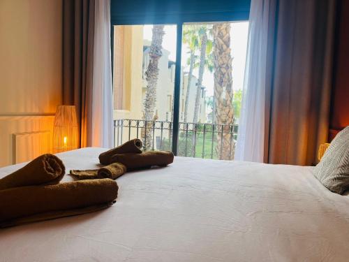 a bed with two teddy bears on it with a window at Casa André - 3 Bedroom Roda Golf apartment nearby entrance and clubhouse in Roda