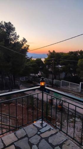 a train is coming down the tracks near a fence at My Place 2 in Agios Spyridon