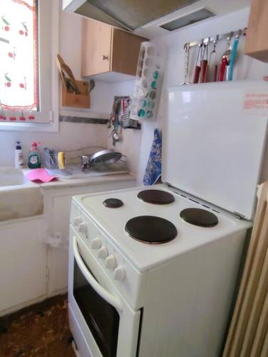a kitchen with a white stove and a refrigerator at My Place 2 in Agios Spyridon