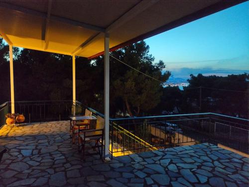 a patio with a table and chairs on a balcony at My Place 2 in Agios Spyridon