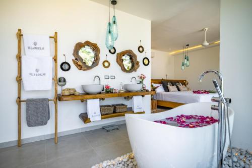 a bathroom with a bath tub and a bedroom at Villa Manglar in Las Terrenas