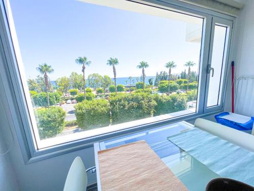 a room with a large window with a view of the ocean at Panoramic Sea View Apt - 2bed in Limassol