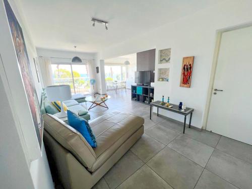 a living room with a couch and a table at Panoramic Sea View Apt - 2bed in Limassol