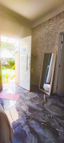 a room with a door and a tile floor with a mirror at Biomas Hotel in Brotas
