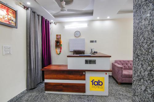 an office with a reception desk and a couch at FabHotel Hari Residency in Chandīgarh