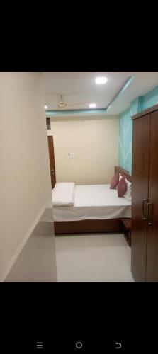 a small bedroom with a bed in a room at HoTE 56 indore in Indore